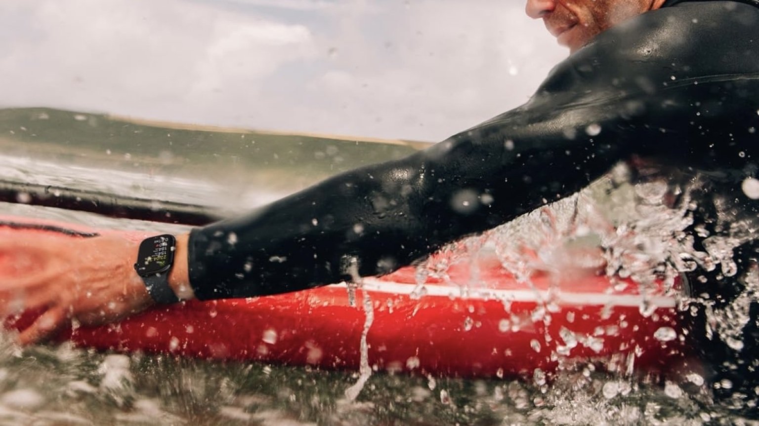 person wearing apple watch on surfboard