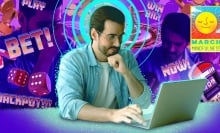 A man is surrounded by visual prompts to gamble.