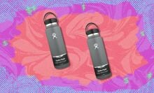 two grey Hydro flask water bottles on a background that's purple, pink, and neon orange