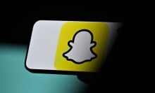 A slightly out of focus Snapchat logo on a phone.