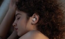 a person sleeps on their side while wearing the soundcore sleep a20 earbuds