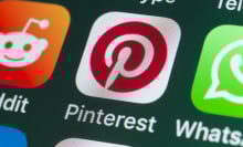 The buttons of the app Pinterest, surrounded by Reddit, Whatsapp, Skype and other apps on the screen of an iPhone.