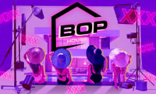 the back of four women sitting at the edge of a pool, with bop house logo above