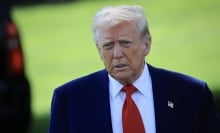 President Donald Trump on a green lawn.