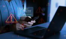 Businessman holding phone with scam message on digital screen