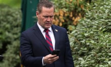 National Security Advisor Michael Waltz looks at his phone
