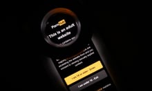 In this photo illustration, the age-restriction warning screen of the website PornHub is displayed on a digital screen