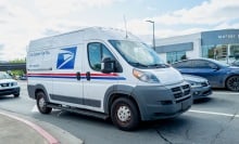 the new usps duck truck in a parking lot