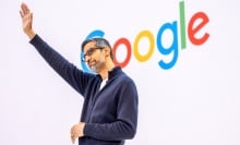 Sundar Pichai acknowledges the crowd in front of a Google logo
