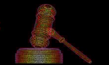 A gavel made out of multicolored lines of code on a black background.