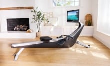 the hydrow pro rowing machine in a bright living room in front of a fireplace
