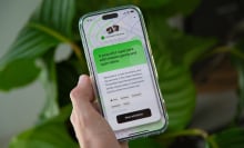 a hand holding a phone with the happn app open, with the app recommending 'a peaceful royal park with hidden gems and open skies'