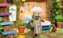 The green tiny chef character wearing a chef's hat and taking a phone call.