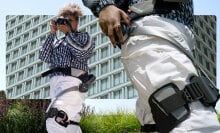 Hiker wearing Hypershell exoskeleton taking photos of the outdoors