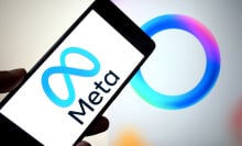 A Meta logo is seen displayed on a smartphone with a Meta AI logo in the background.