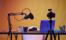 a microphone, tripod and camera in home studio