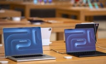 macbook pros on display at an apple store