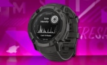 The Garmin Instinct 2X Solar Smartwatch on a purple background