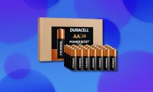 Duracell batteries sit in rows in front of a brown Duracell box. Behind this is a blue background with blue circles