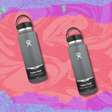 two grey Hydro flask water bottles on a background that's purple, pink, and neon orange