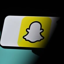 A slightly out of focus Snapchat logo on a phone.