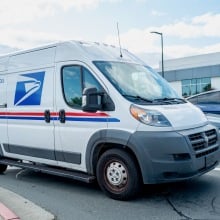 the new usps duck truck in a parking lot