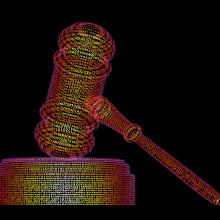 A gavel made out of multicolored lines of code on a black background.
