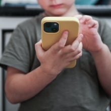 A child looks at a smartphone.