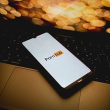 The Pornhub logo is being displayed on a smartphone