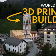 A drone shot captures the tall white Tor Alva at dusk, as lights have just gone out. It's surrounded by Mulegns' traditional houses, and the Alps are seen in the background