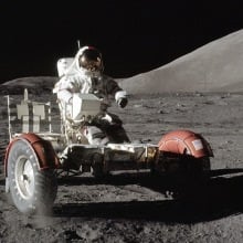 Apollo 17 astronaut driving a moon buggy