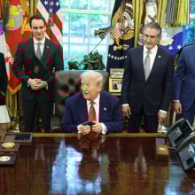 US President Donald Trump, center, holds an Apple Inc. iPhone