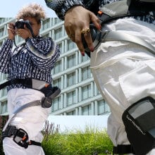 Hiker wearing Hypershell exoskeleton taking photos of the outdoors