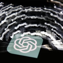A multi-exposure shot of the ChatGPT logo and glowing keyboard keys.