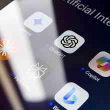 A phone screen showing a folder of AI chatbot apps, including Claude, Gemini, ChatGPT, CoPilot, and DeepSeek.