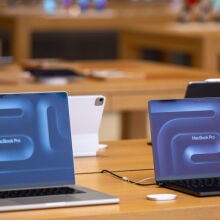 macbook pros on display at an apple store