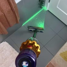 Dyson V12 Detect Slim cleaning bathroom floor with green laser