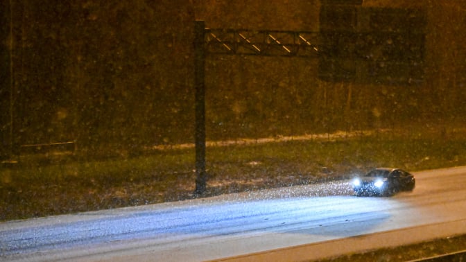 A car drives along a road during a winter storm on January 21, 2025 in Tallahassee, Florida