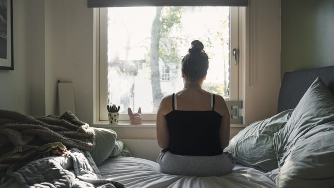 A teen in their bedroom.