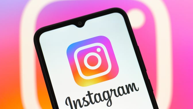 In this photo illustration, the Instagram logo is seen displayed on a smartphone screen. 