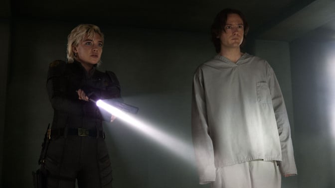 'Thunderbolts*' characters Yelena and Bob stand in a dark room. 