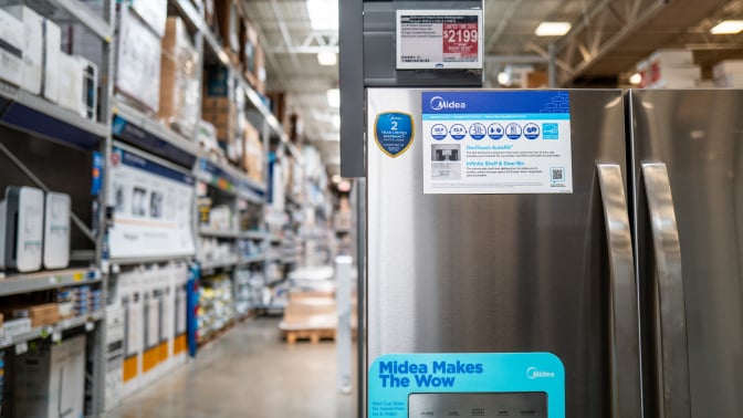 A fridge on sale in a home improvement store, displayed an energy star logo.