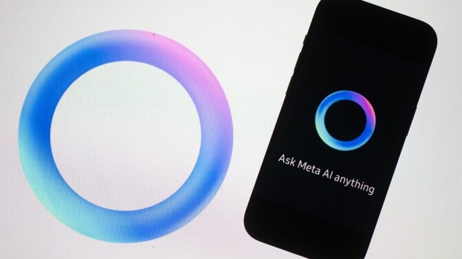 A phone displaying the circular Meta AI logo and text that reads "Ask Meta AI anything."