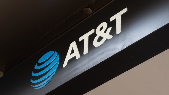 Illuminated AT&T logo sign on dark storefront awning, San Francisco, California, May 13, 2025.
