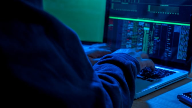 Shady figure on a computer
