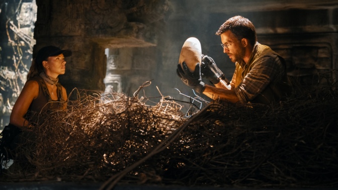 Scarlett Johansson and Jonathan Bailey sit in a nest of dinosaur eggs in "Jurassic World Rebirth."