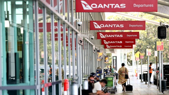 qantas airline signs at an airport