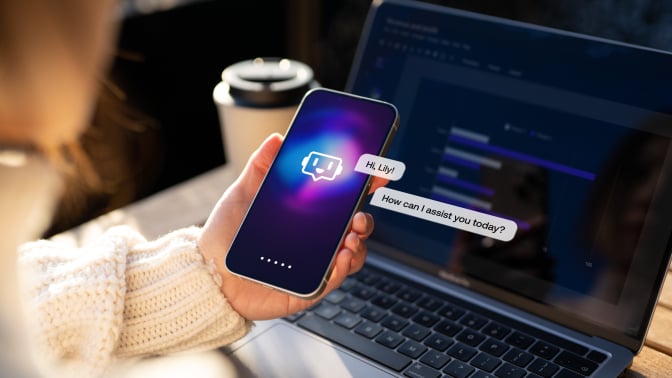 Female hand holding smartphone showing chatbot conversation with virtual assistance app. 