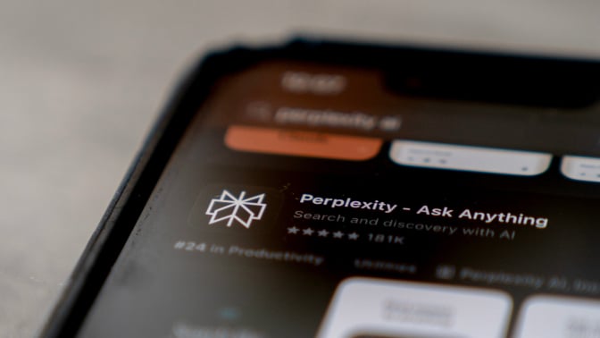 A zoomed in photo of a phone screen displaying the Perplexity app in the Apple App Store. 