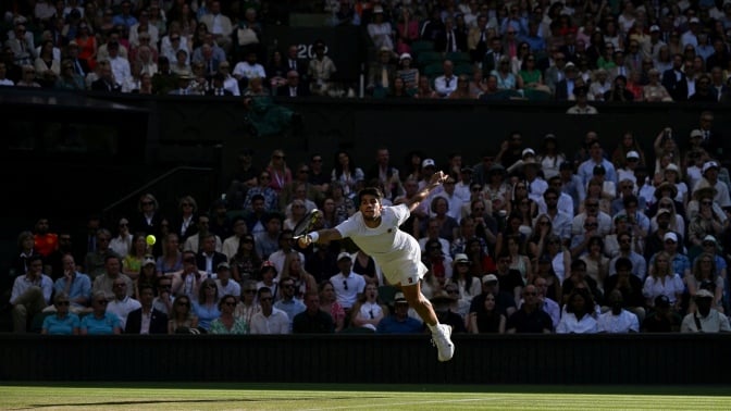 Carlos Alcaraz jumps to play a forehand